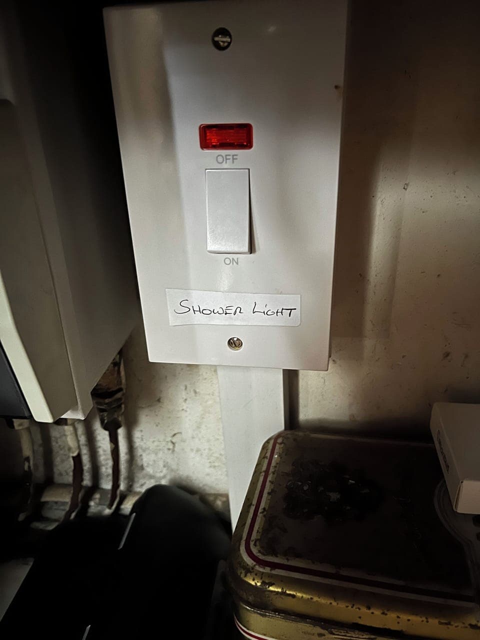 Shower light in cupboard behind TV