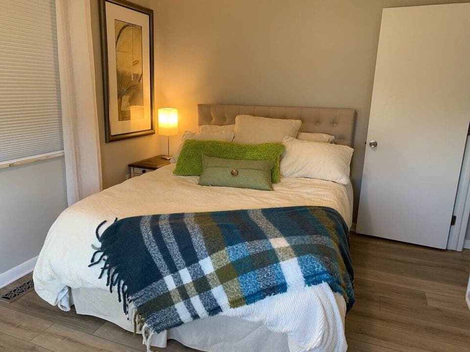 Read in bed with a cozy light and fluffy pillows.