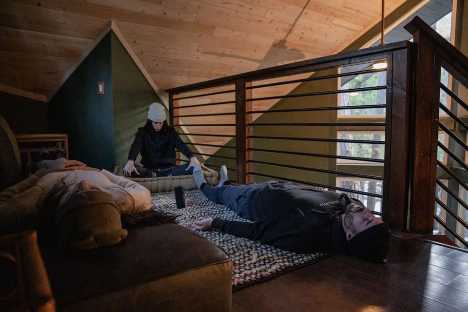 The loft can also be a perfect place for breathwork, meditation, or yoga with views out into the forest through the A-Frame windows.