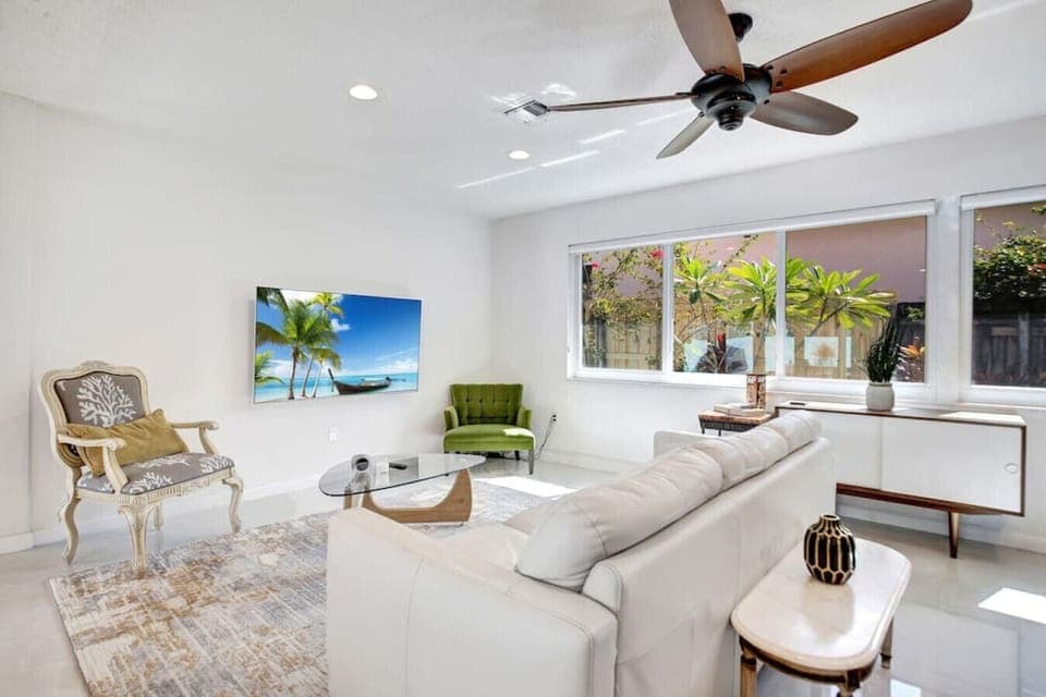 Picture yourself sinking into the plush cushions of a cozy couch, surrounded by the warm glow of natural light.  Catch up on your favorite shows on the large smart TV.