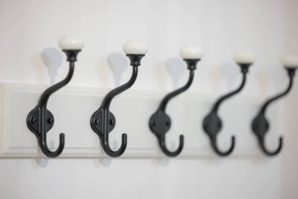 Decorative hooks mounted on the wall for hanging towels or coats.

