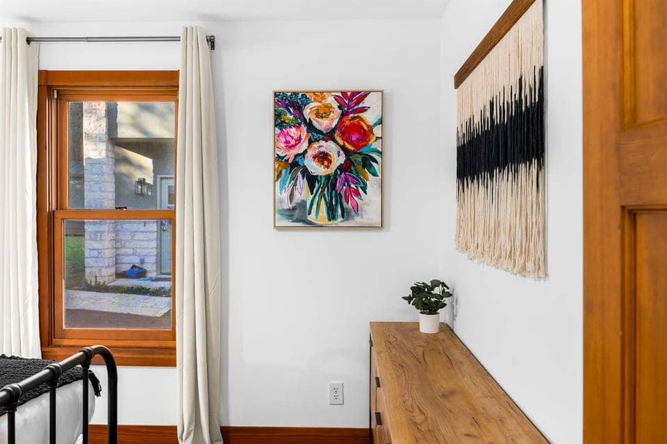 A tastefully designed room corner, complete with a stunning wall painting.