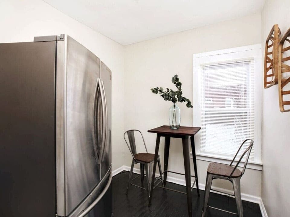 Full-size stainless fridge and bistro table seating for 2