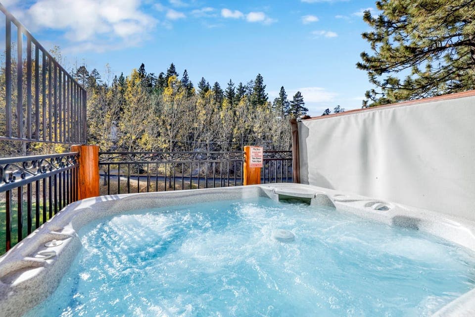 Private outdoor hot tub, surrounded by tall pines, perfect for relaxing under the trees after a day of adventure—enjoy peaceful forest views, fresh air, and a truly rejuvenating stay.