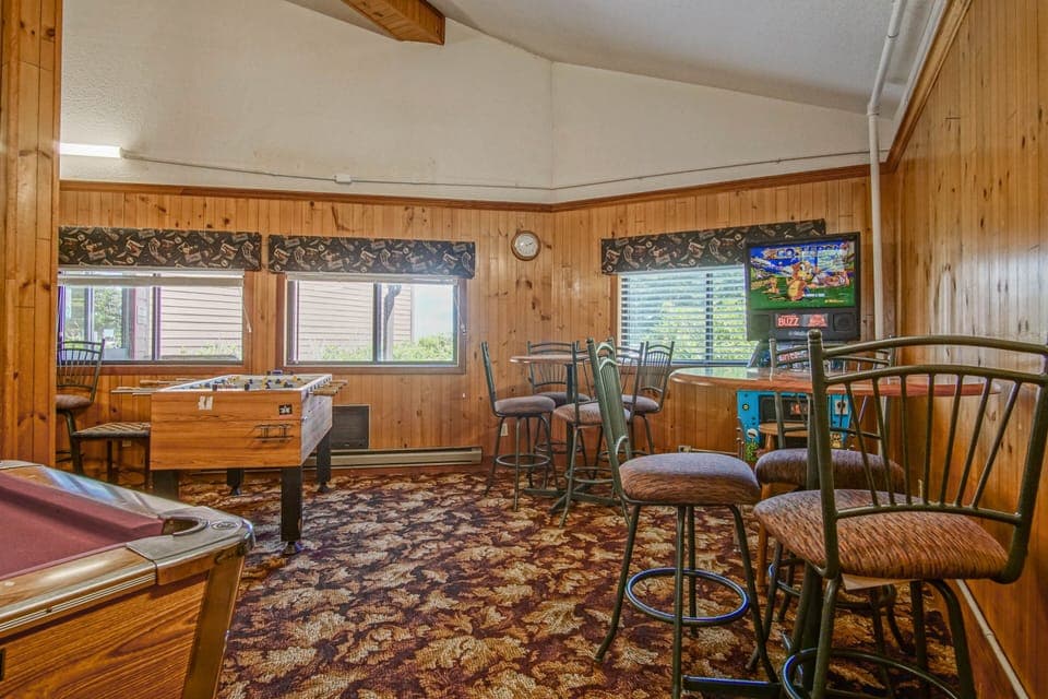 Another view of the Hearth Room/common area with a fireplace, TV, pool table and games