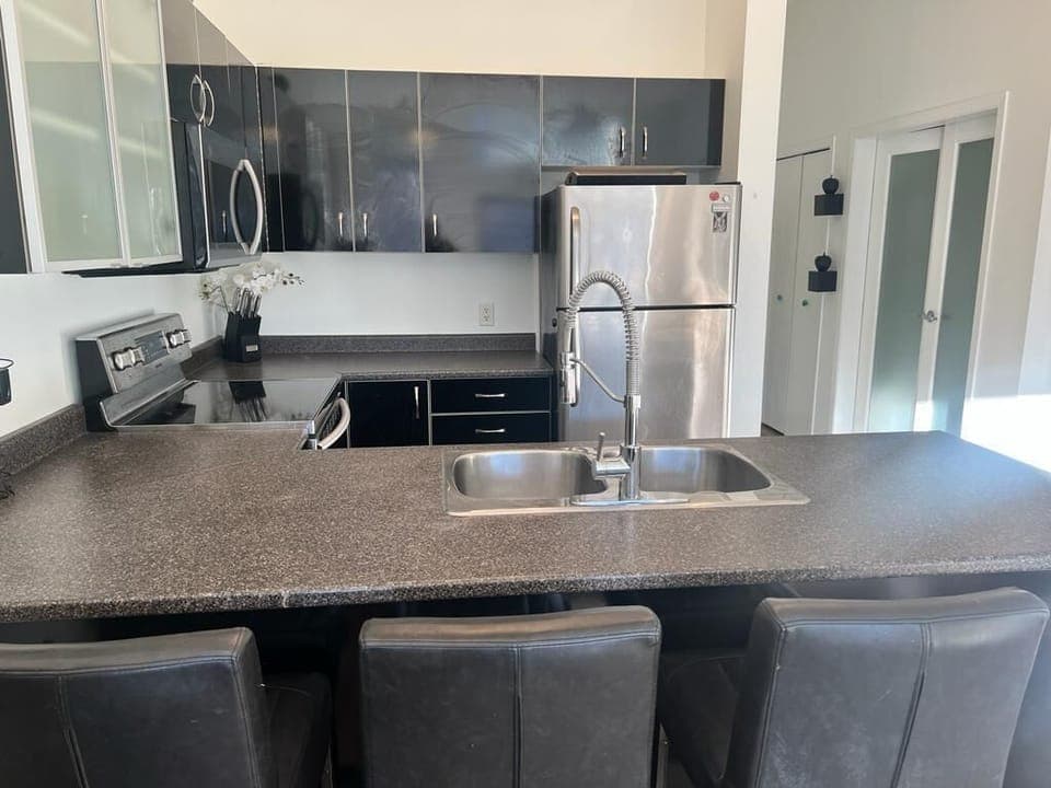 Modern kitchen with sleek appliances and spacious island seating