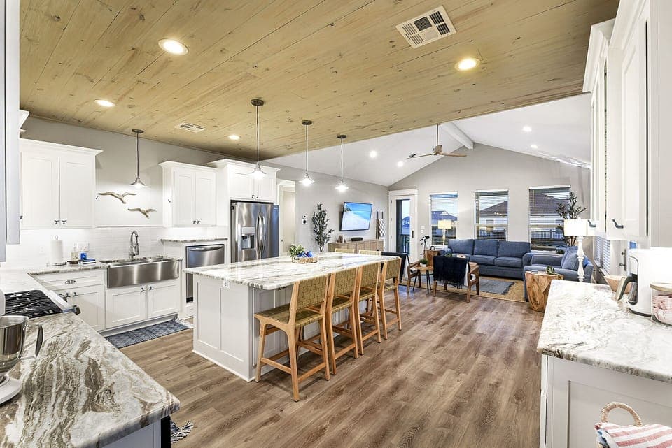 Kitchen with stainless steel appliances, gas range, mini bar.