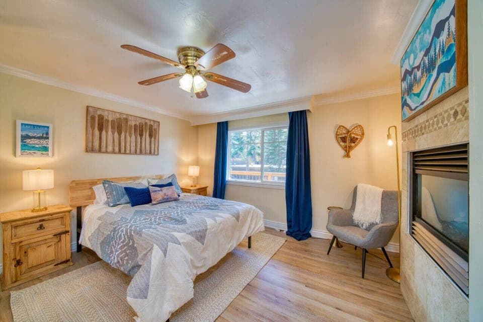 Master bedroom equipped with queen size bed and gas fire place, along with the attached master bathroom.