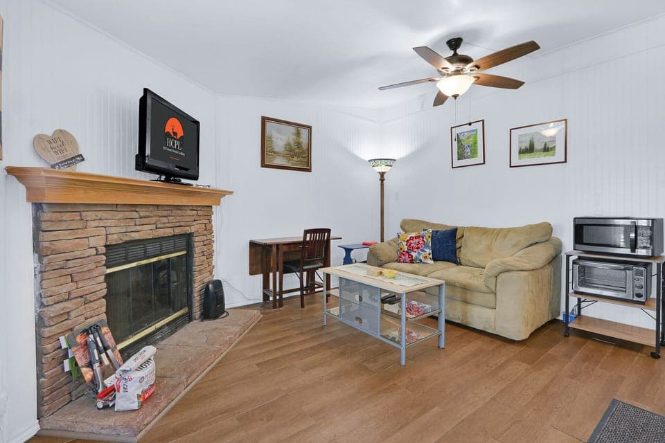 The living room features a large fireplace