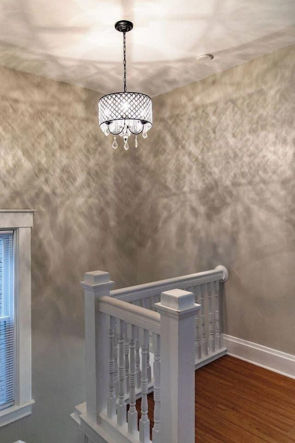 Elegant chandelier, adding a touch of sophistication and charm to the room, creating a warm and inviting ambiance.