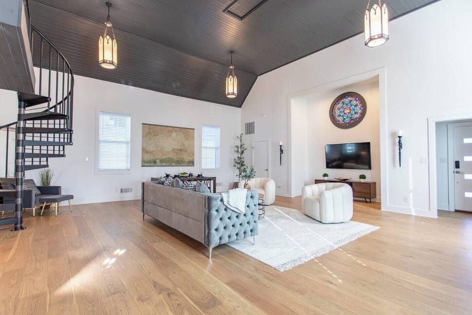 Spacious and wide living area featuring a comfortable couch and a TV, creating a perfect space for relaxation, entertainment, and socializing.