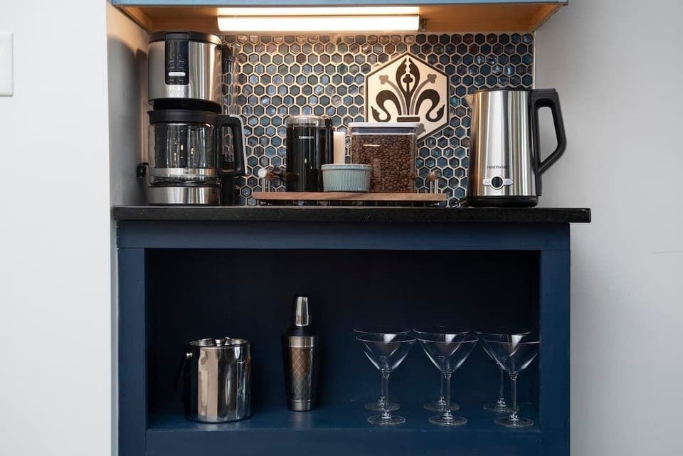 The fully equipped kitchen has everything you need, including cooking utensils, dishes, and cups. A coffee bar, complete with sugar and creamer, adds convenience, and the island seats 3 comfortably for dining or meal prep.