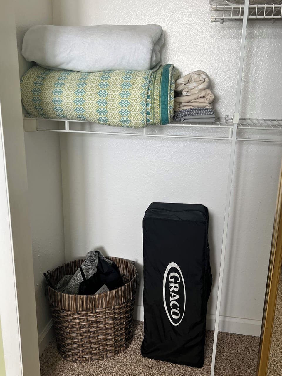 Bedroom one closet with pack and play and extra blankets