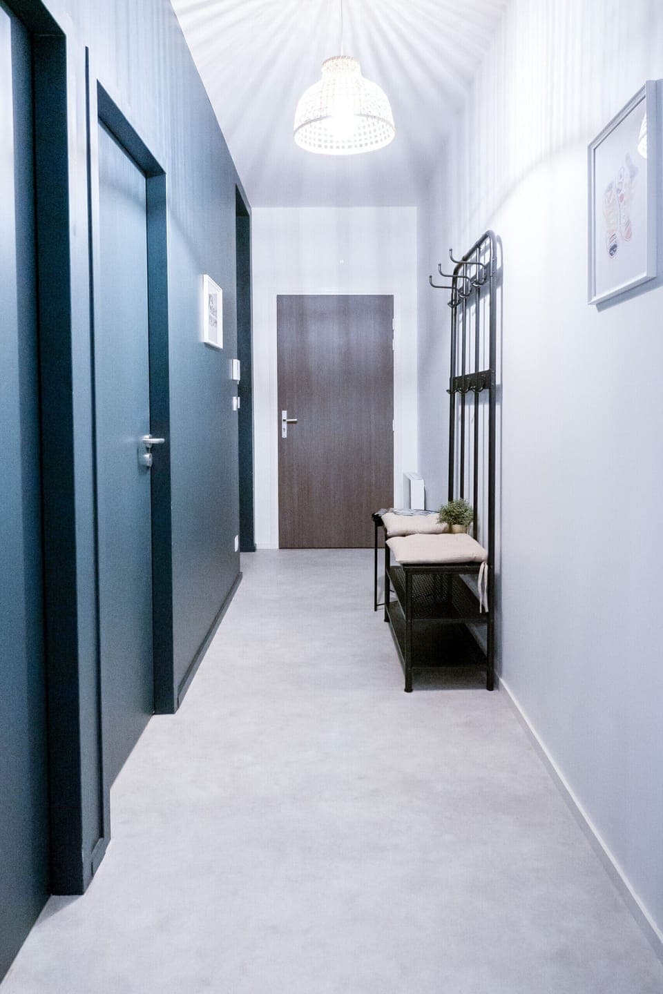 "Elegant Entryway: White and Gray Wall with Coat Rack"