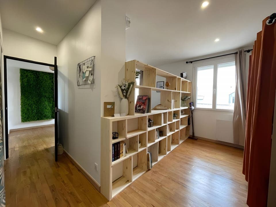 Modern shelf elegantly separates the living room, adding a touch of sophistication.