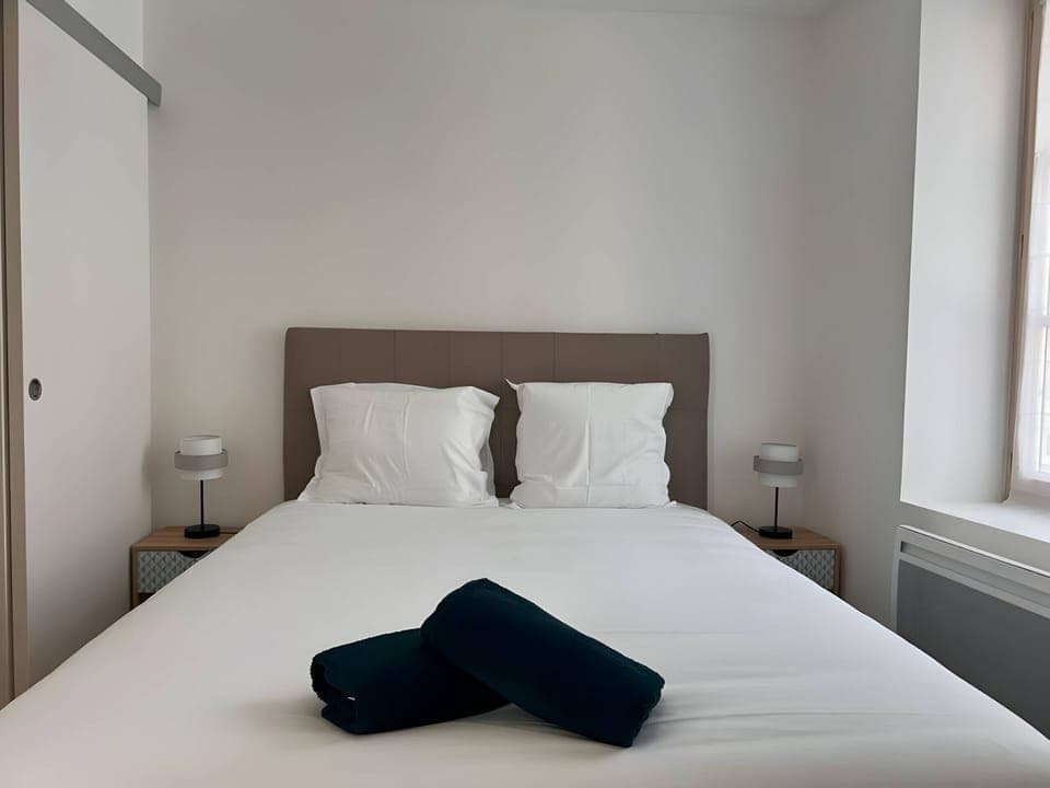 "Enjoy the warm atmosphere of the "Le Donjon" apartment's bedroom. Take advantage of the office space to work or relax."