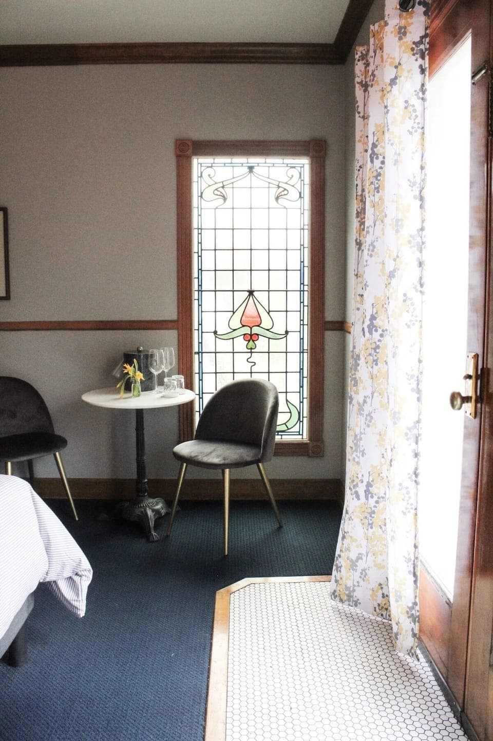 Sip morning coffee beside stained glass and sunny curtains.