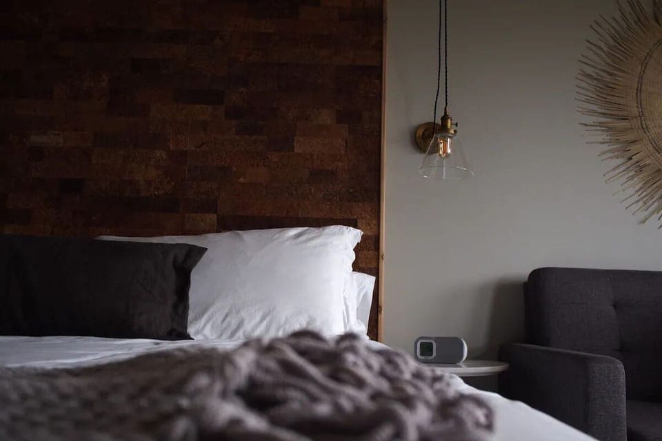 Relax into plush pillows beside warm textures and ambient glow.