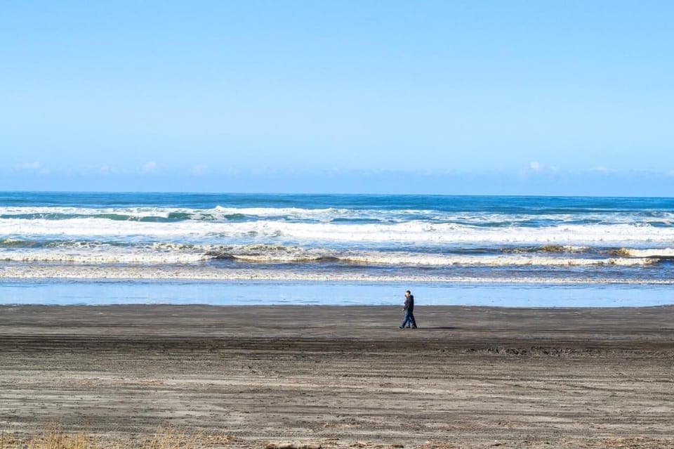 Stroll wide sandy beaches with the surf beside you.
