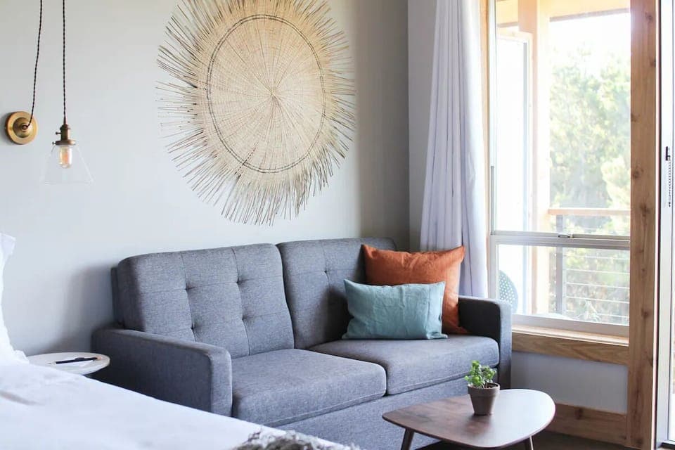 Lounge on the sofa with sunlit views and airy curtains.