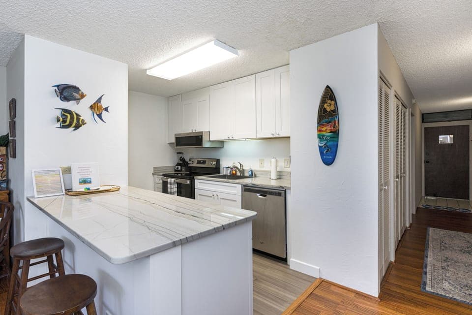The kitchen has updated appliances and new cabinets.