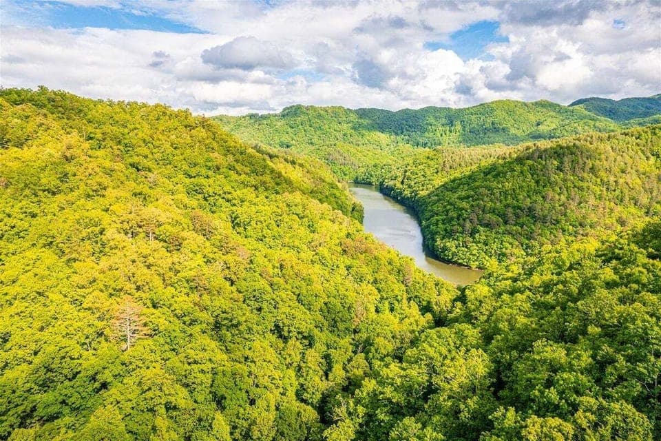 Stunning overlook of Lake Fontana's sparkling waters surrounded by rolling Smoky Mountain ridges.