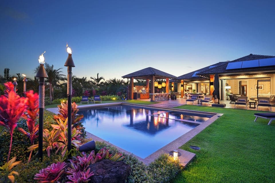 Immerse yourself in luxury at Hale Pakika at Kukui'ula, outdoor living space, ama this pool and spa combo, featuring plentiful seating for sun-soaked gatherings or relaxing days..