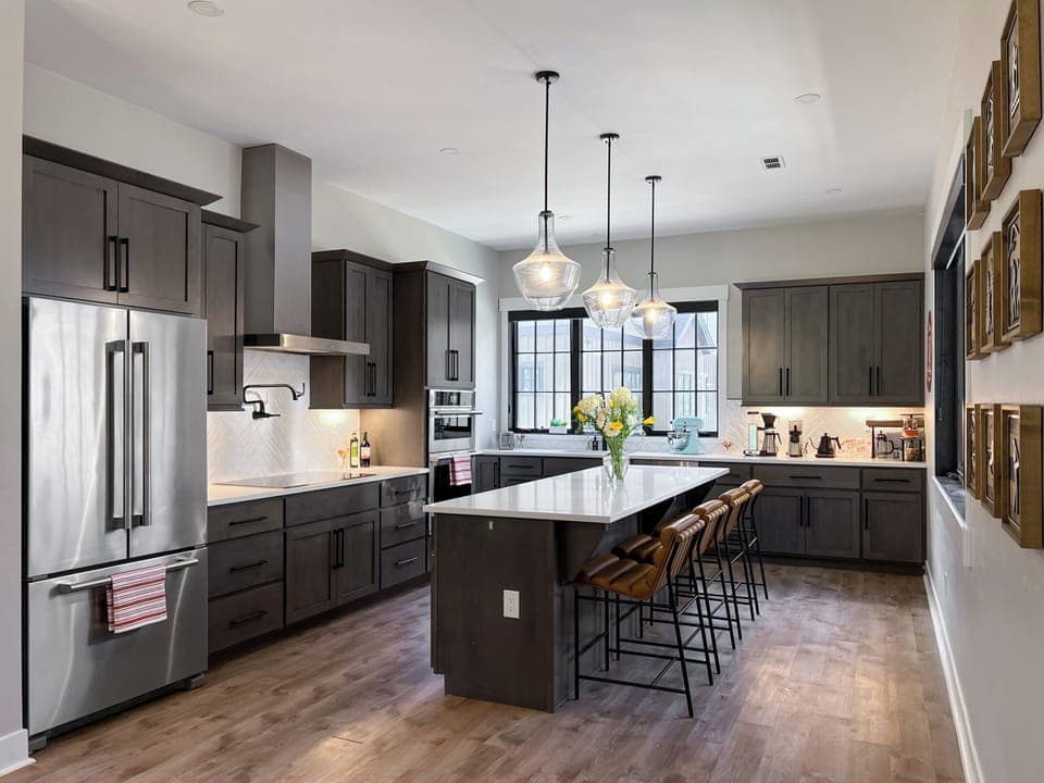 - Chef’s kitchen features a huge island, quartz countertops, and stylish pendant lighting - Sleek appliances, tons of storage, and barstools make it both functional and beautiful - Perfect for group meals, happy hour spreads, or midnight snacks