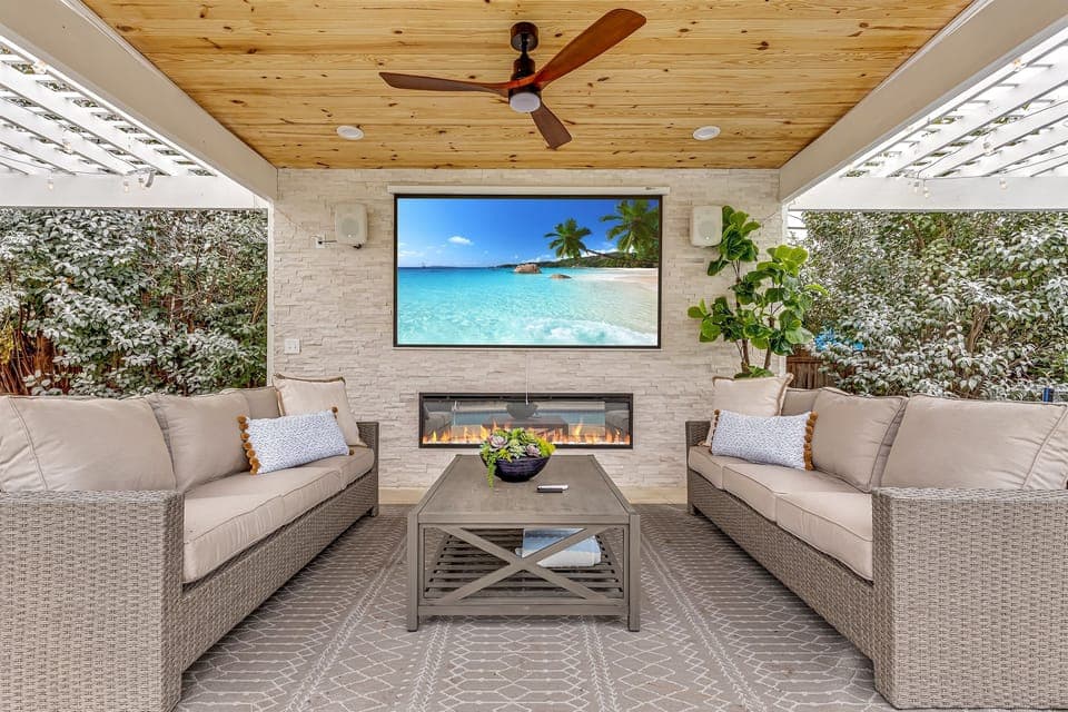 Revel in the comfort of this chic lounge space, where modern design meets home theater under the stars.