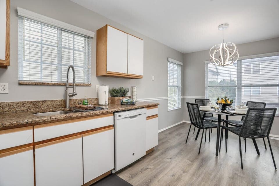 Discover the perfect blend of style and function in this inviting kitchen, featuring elegant granite countertops and a cozy table for four to enjoy delightful meals together.