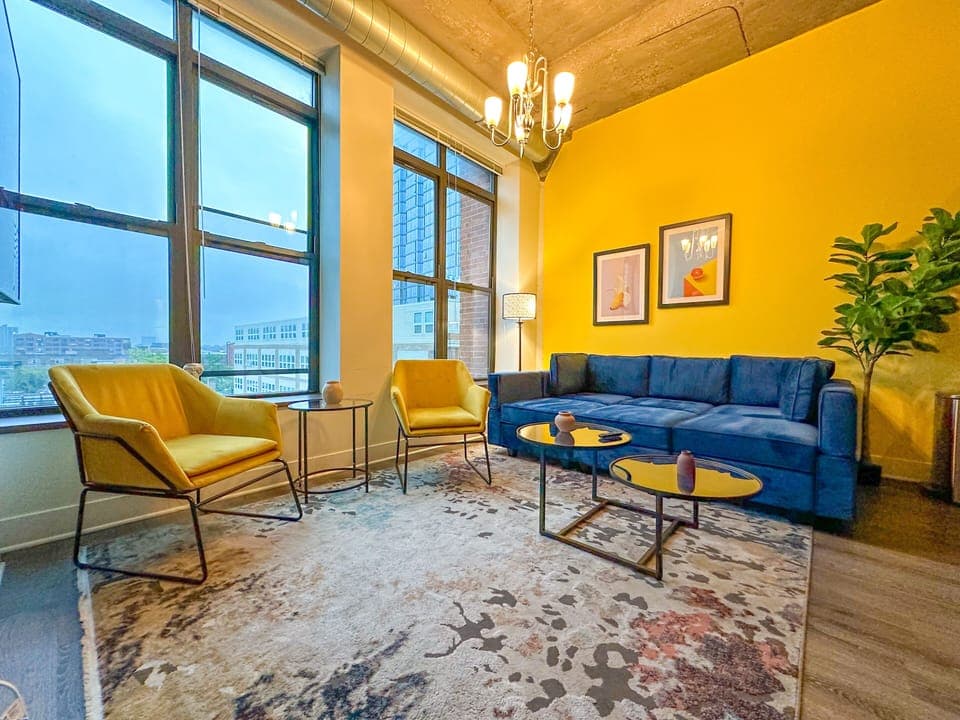 Spacious living room with a lot of natural light and large windows.