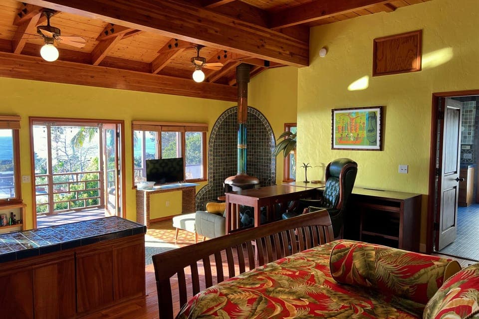 Large studio with a free-standing copper fireplace in the sitting area. 