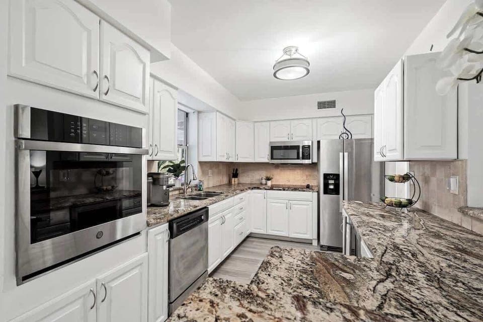 - Bright kitchen with large counters and open window view  
- Stainless steel appliances for easy home cooking  
- Overlooks patio and pool for seamless indoor outdoor flow  