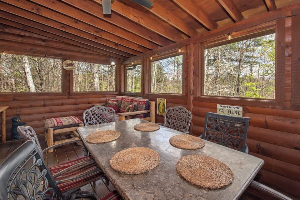 Gather around this rustic dining table where your group meals become memorable moments, surrounded by warm wood beams and peaceful forest views.