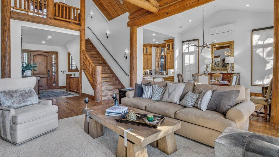Great Room, Main Level - Open-concept space with vaulted ceilings and staircase views