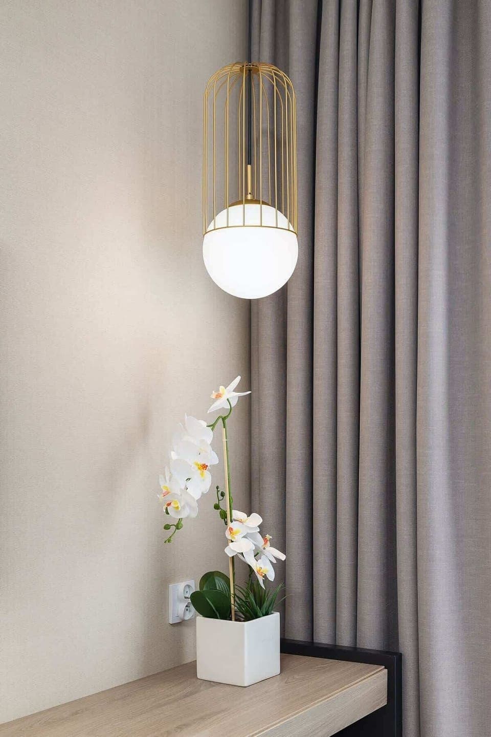 Stylish wall lamp with gold accents and white floral decor.
