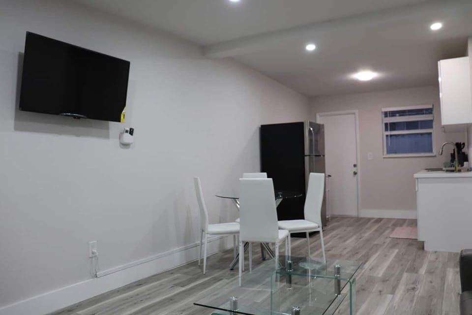 Dining area equipped with a white table and chairs.
