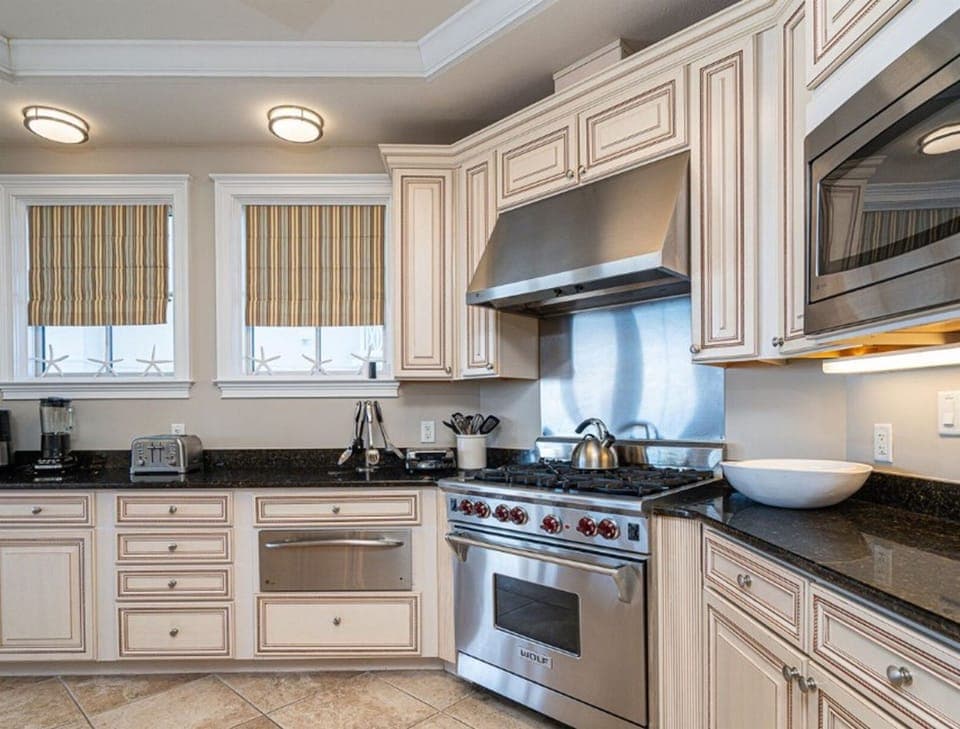 Step into your gourmet kitchen with gleaming granite counters, professional-grade appliances, and warm wood cabinetry perfect for creating memorable meals.