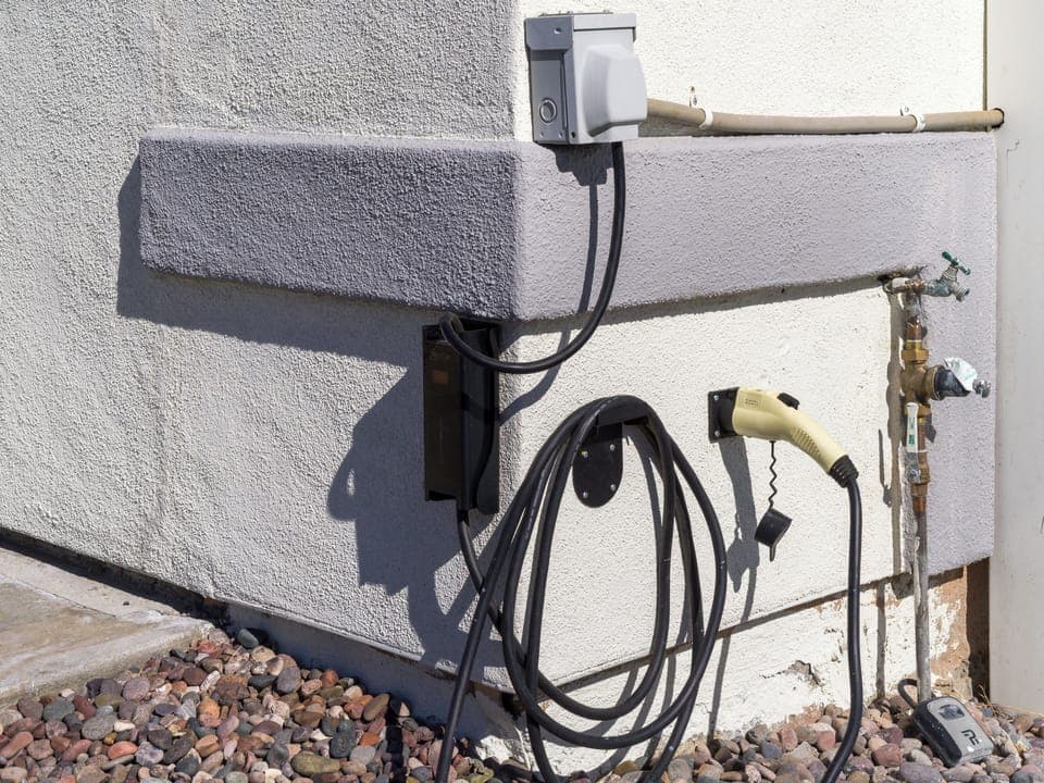 EV charger with optional Tesla adapter.