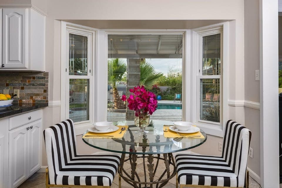 Breakfast Area looking into pool and backyard patios 