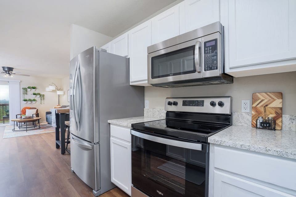 A perfect blend of natural beauty and contemporary design in this kitchen with wooden floors and a black island.