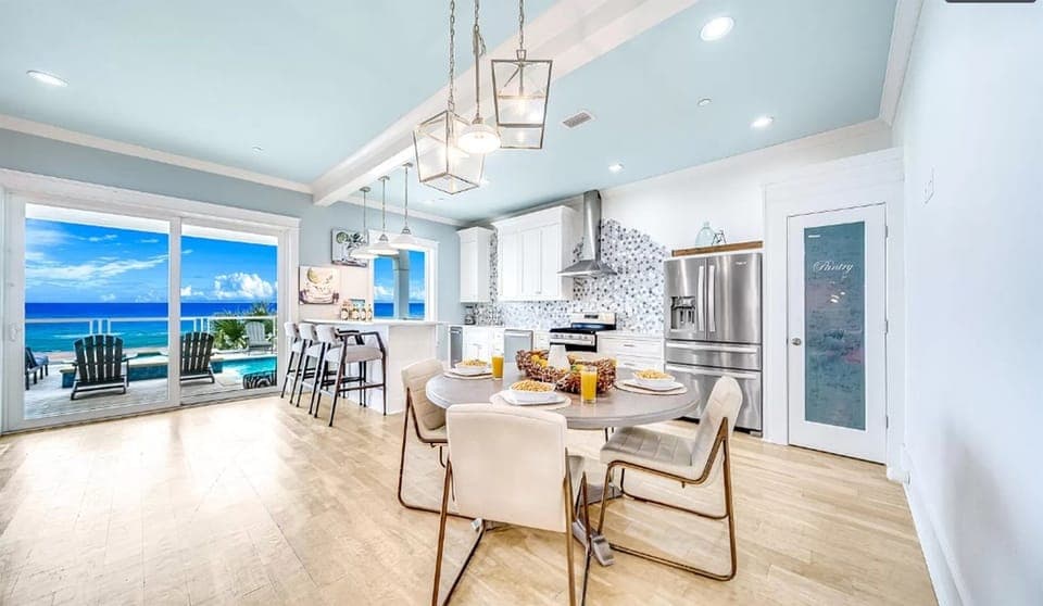 Your dream kitchen opens to endless ocean views, where morning coffee meets sea breeze through expansive windows.