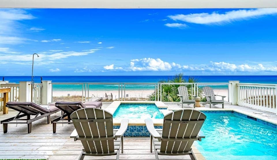 Your private oceanfront pool deck features stunning turquoise views, comfortable loungers, and direct beach access for the ultimate tropical escape.