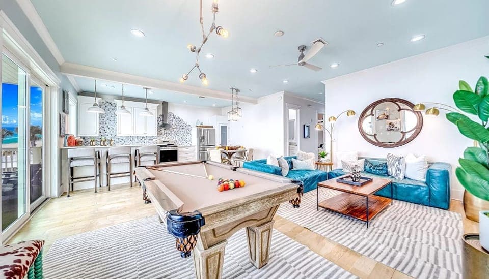 Your stylish retreat features a sleek pool table perfect for friendly competition, flowing seamlessly into the modern kitchen and cozy living space.