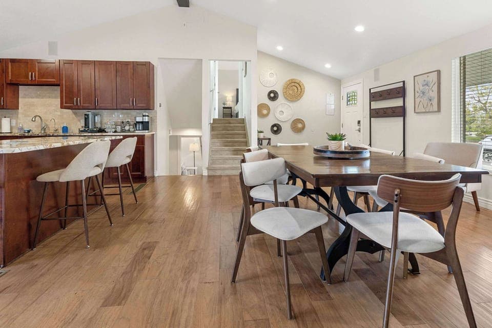 The kitchen is open to the front door and dining table.