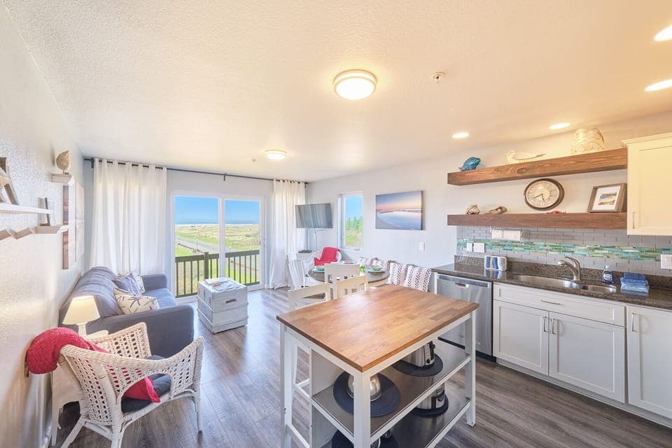 Living room with conjoined dining room and kitchen.