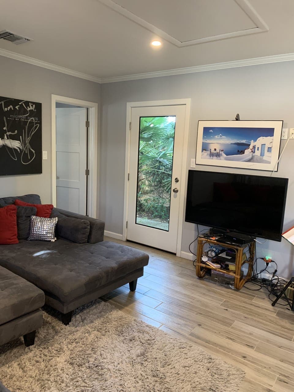 Flat screen TV and door to back patio.