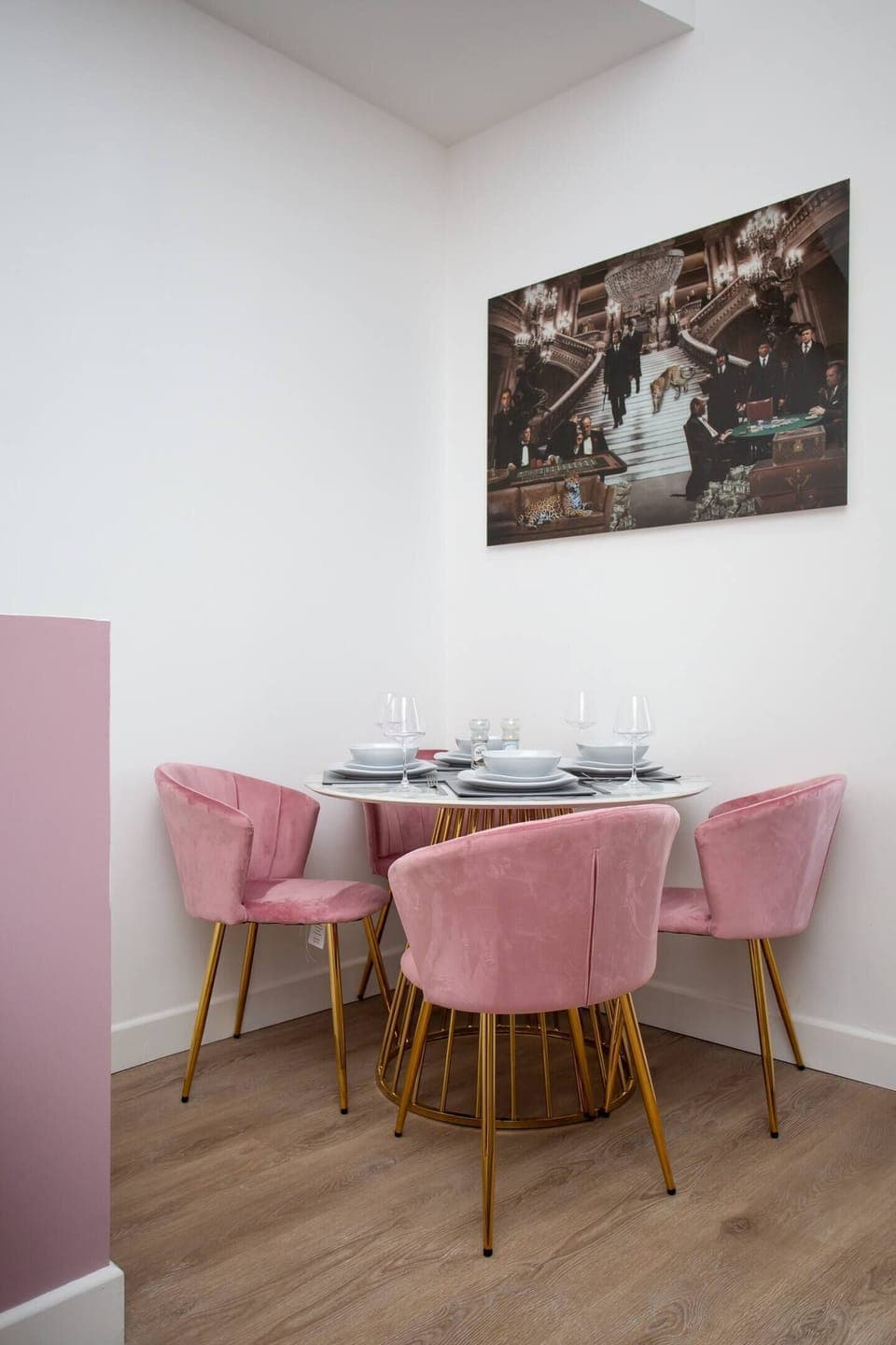  Gather with loved ones in the inviting dining area, where a sleek table for four awaits beneath the soft glow of lighting. 