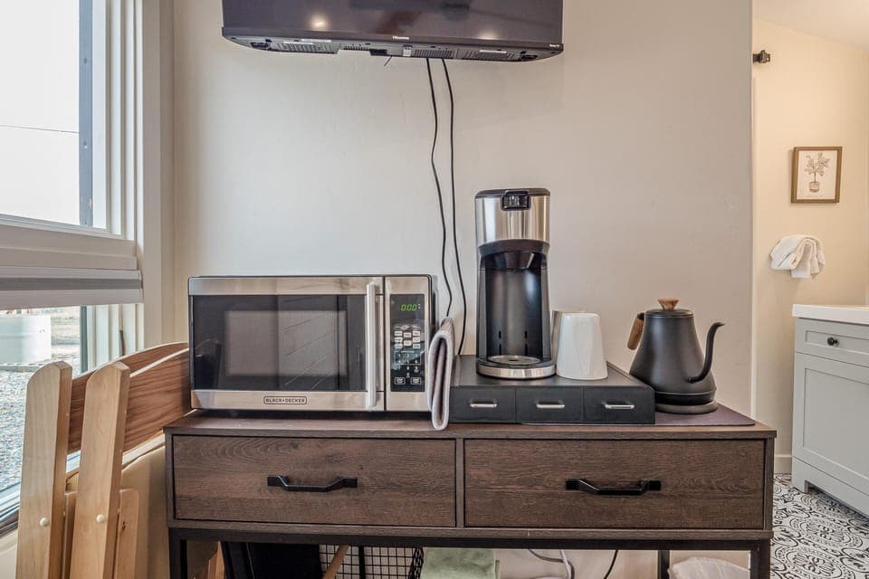 Kitchenette includes microwave, keurig, teapot, and minifridge