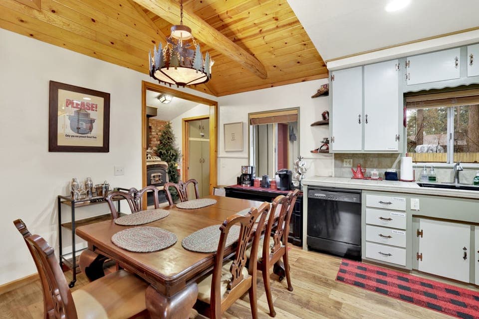 “Dining area beside the kitchen with elegant table setting, warm lighting, and inviting atmosphere for shared meals